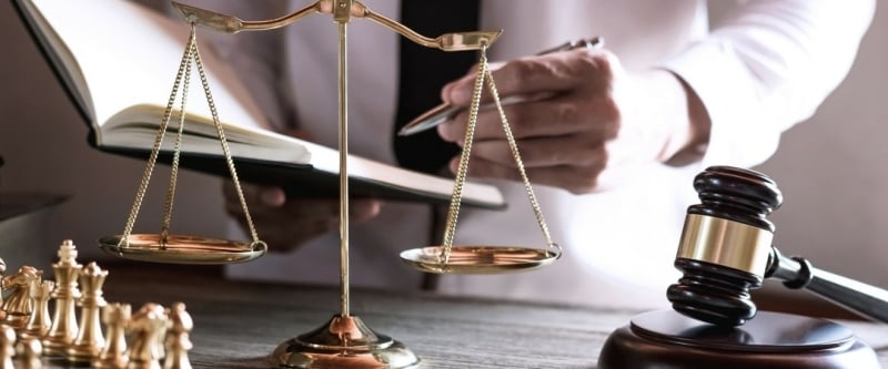 gavel-on-wooden-table-and-lawyer-or-judge-working-with-agreement-in-courtroom-theme-justice-and-law_t20_ozz9je-800x333